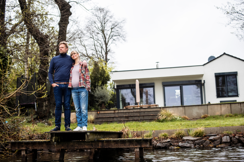 man und frau im garten vor einem haus